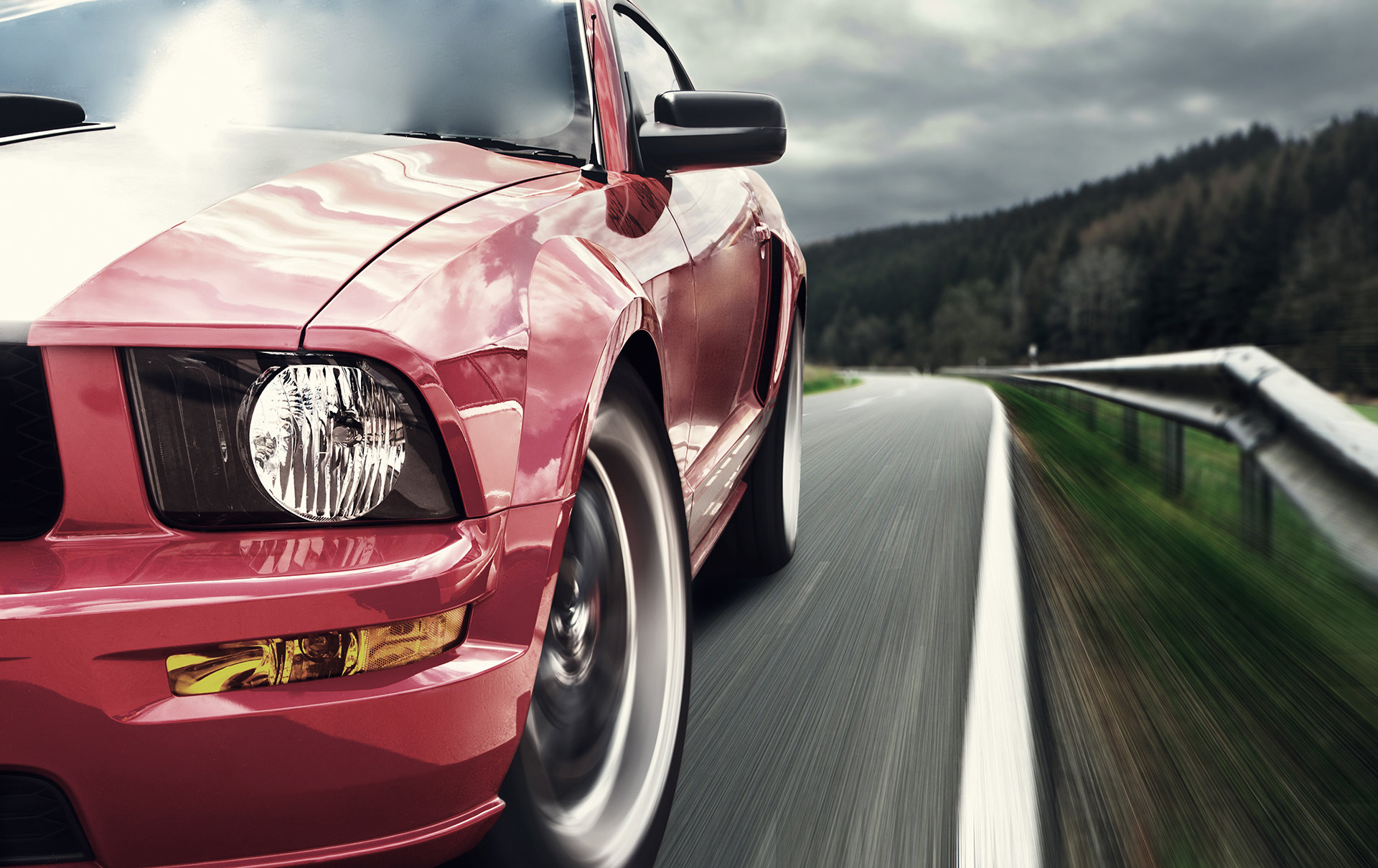 A red sports car on an open road