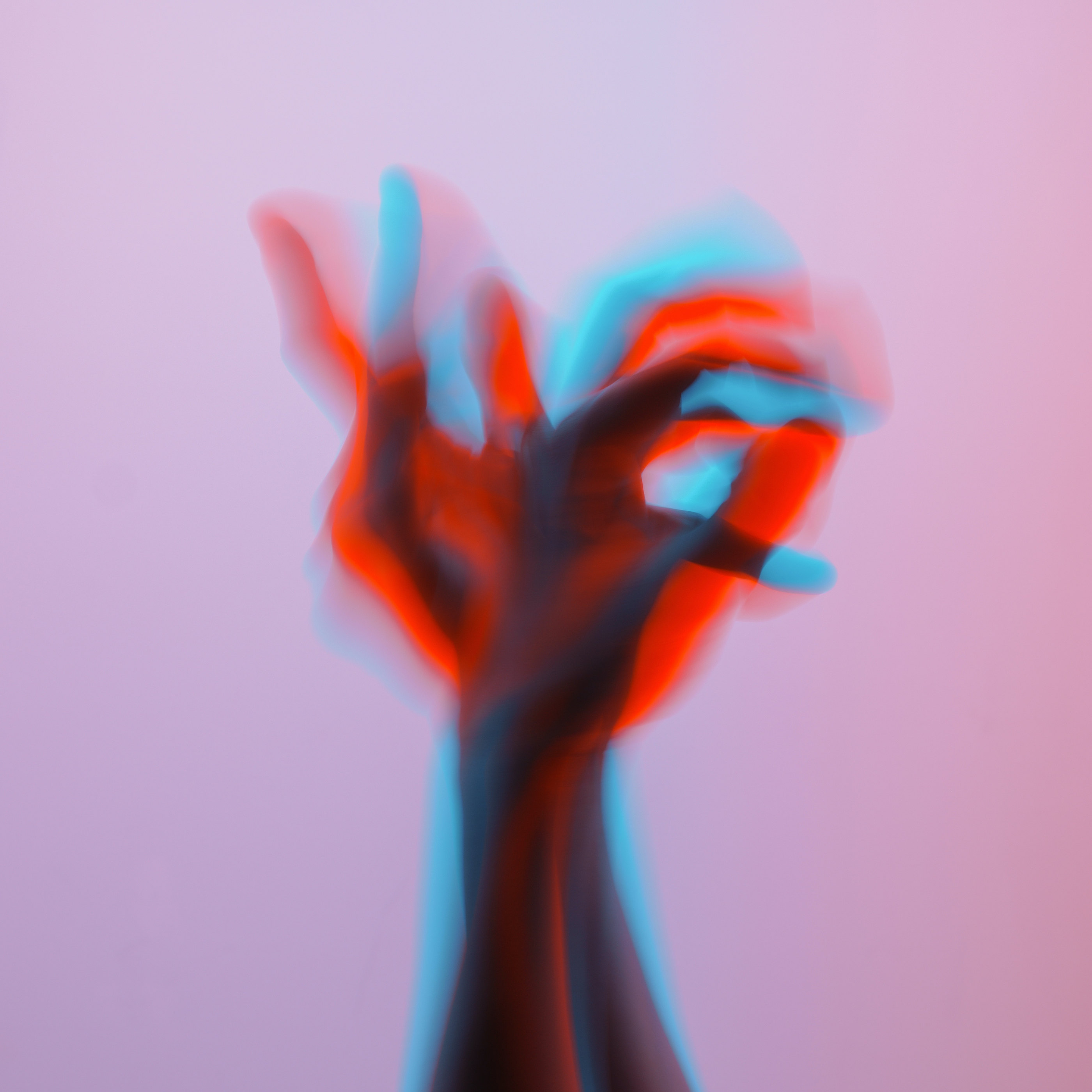 A hand in motion with a red and cyan colour shift effect