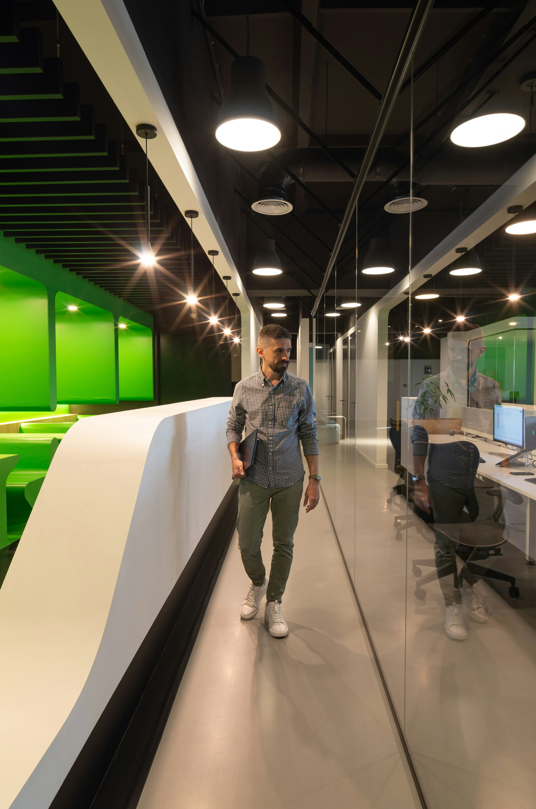 A person walking through a bright modern corridor