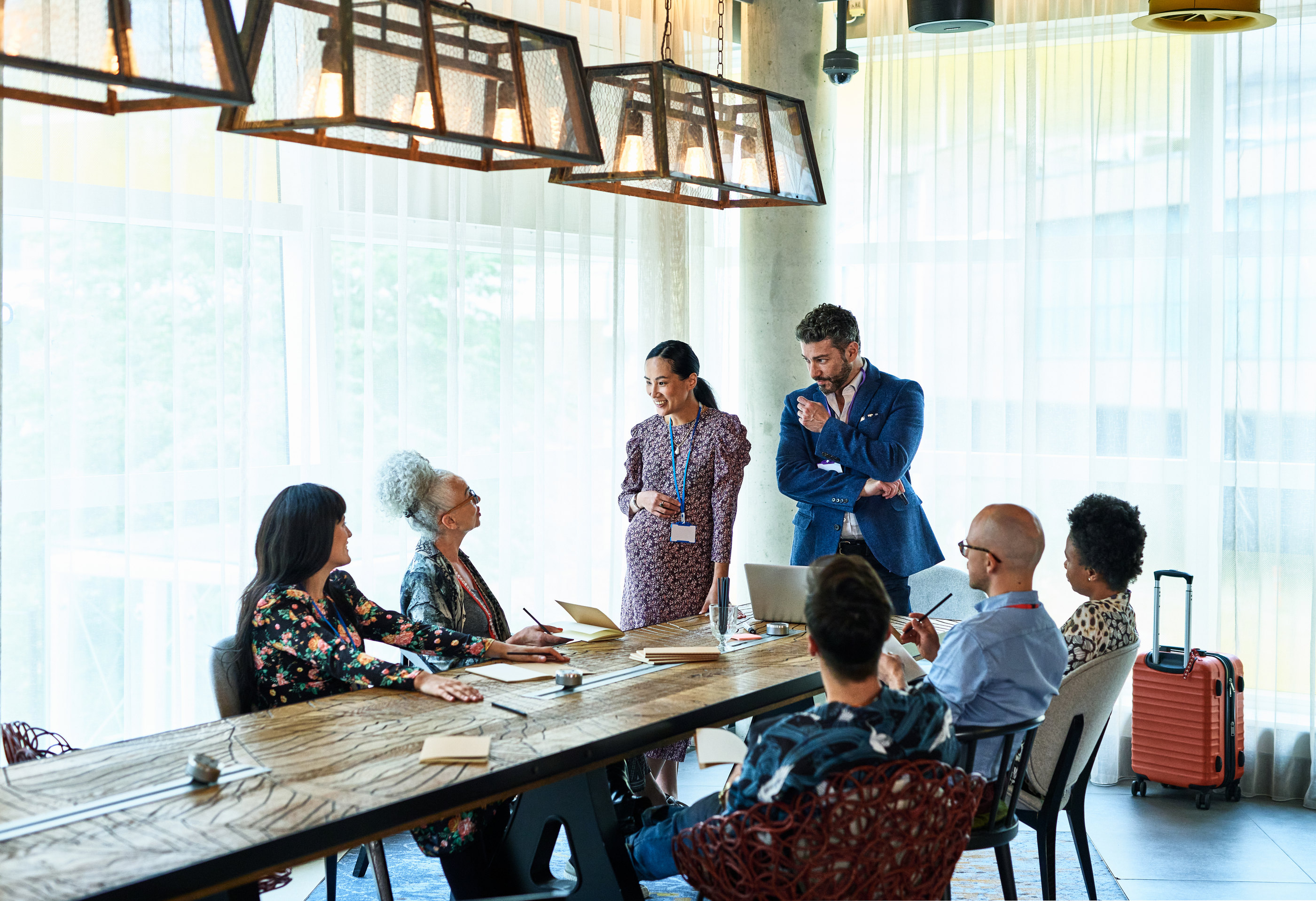 A business team meeting around a long table